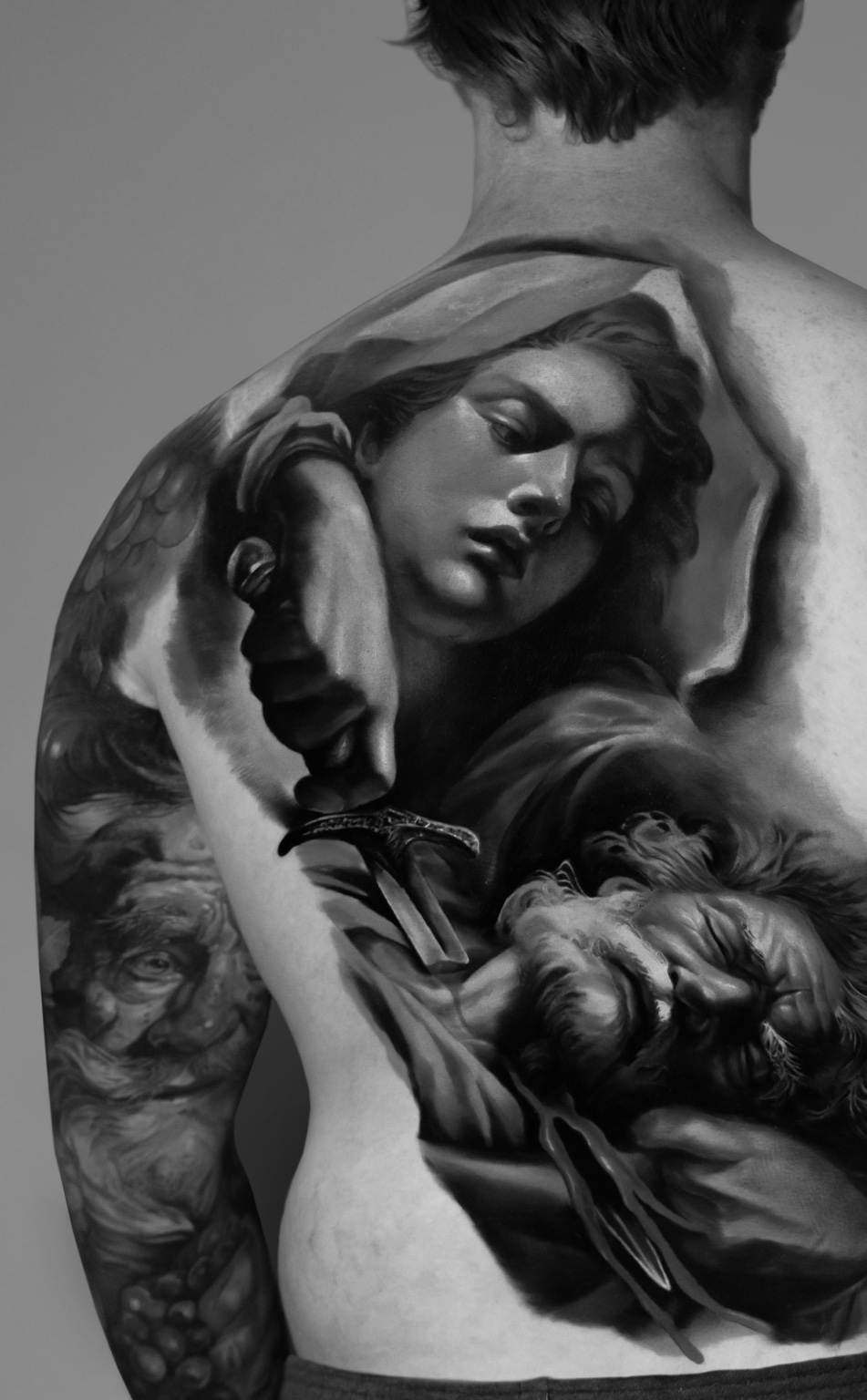 Black-and-grey fine-art back piece tattoo by Tony Vilella
