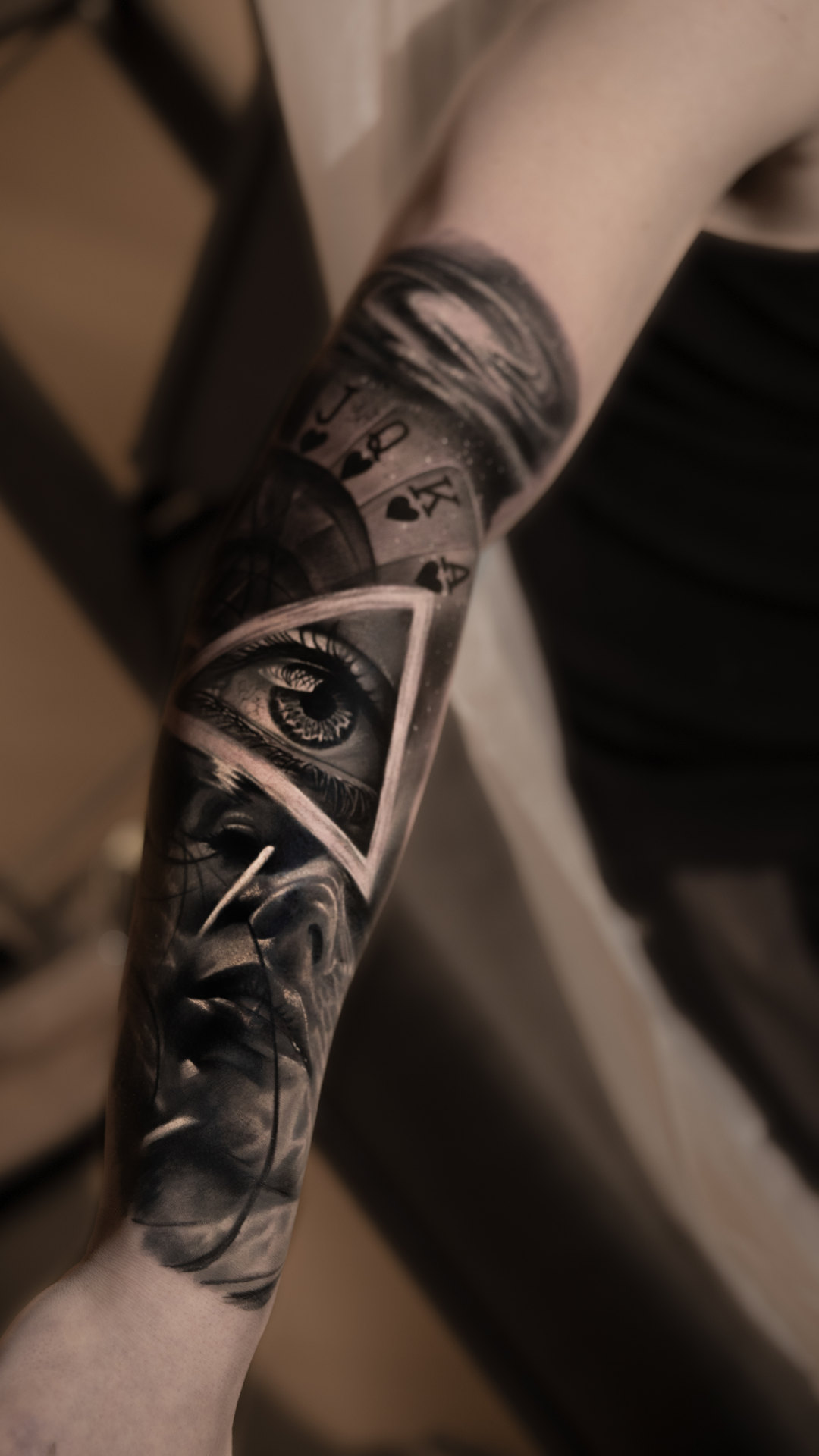 Black-and-gray eye and architectural forearm tattoo by Tony Vilella