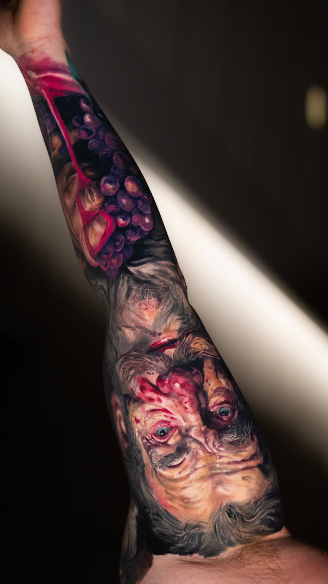 Surreal color realism forearm tattoo by Tony Vilella